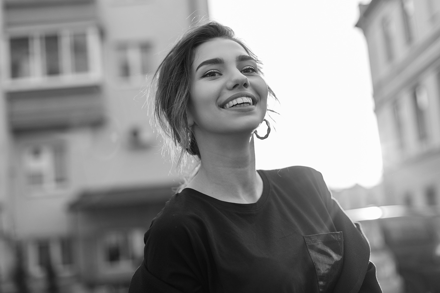 Young happy woman with a beautiful smile in a stylish T-shirt in